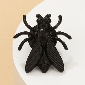 Macro shot of creative black cicada insect earring with detailed wing textures