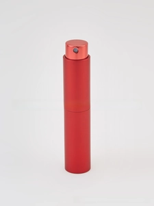 Close-up of matte red aluminum spray bottle with press-top atomizer and metallic texture