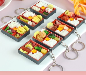 Macro shot of assorted miniature Taiwanese bento box keychains with detailed food models