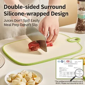 Antibacterial beige cutting board with green non-slip edges for kitchen fruit and meat prep