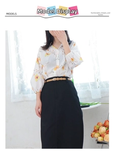 Close-up of a slim brown leather belt accenting a black midi skirt and floral blouse