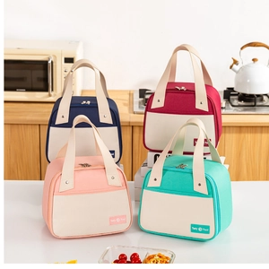 Stack of colorful insulated lunch bags with trapezoidal shape and front pocket detail