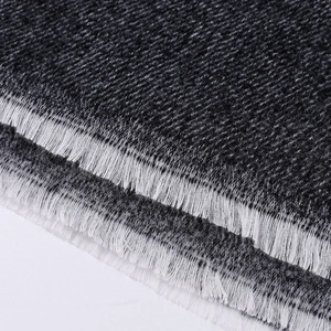 Detailed macro view of the knitted fabric texture and fringes on a monochrome shawl