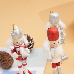 Detailed view of three 12cm wooden Christmas nutcracker soldiers with festive glitter finish