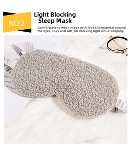 Detail of plush teddy fleece eye mask with silk lining and elastic strap on soft background