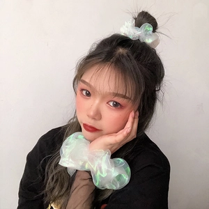 Iridescent green and white organza scrunchies shown on hair bun and as a necklace