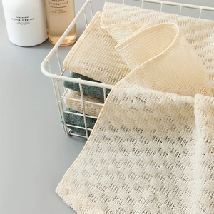 Exfoliating back scrubber set in beige and dark green mesh fabric for bath and shower