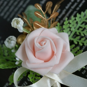 Light pink foam rose boutonniere with golden metal leaves and white satin ribbon