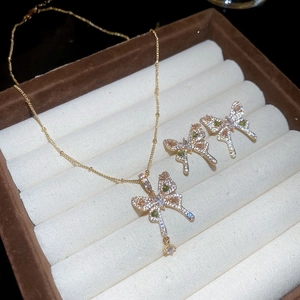 Close-up of butterfly jewelry set with zircon stones in a velvet box