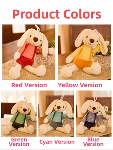 Detail showing five colorful long-eared plush rabbits in striped outfits on a wooden desk
