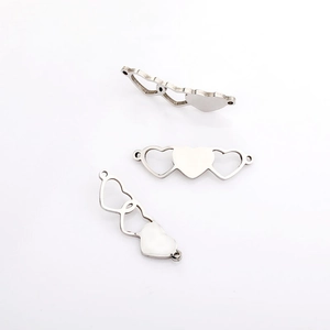 Close-up of silver heart-shaped magnetic clasp connectors for jewelry making