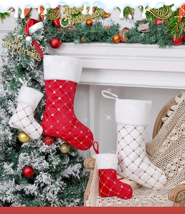 Detail of red and white sequin Christmas stockings with diamond pattern and fur trim