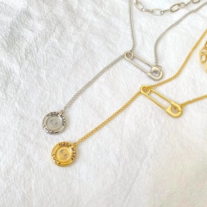Layered gold and silver stainless steel necklaces with paperclip and luck button charms