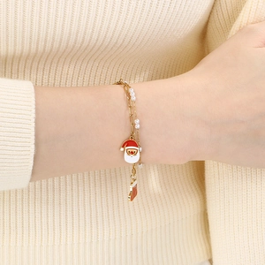 Detail of Christmas bracelet with Santa, stocking charms and white pearls on a model