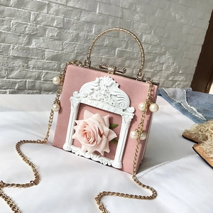 Detailed shot of a pink floral handbag featuring 3D rose decor and pearl metal chain