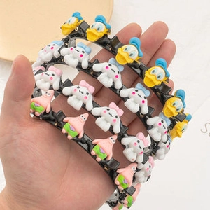 Detail of cartoon headband featuring double-layer hair clips with various cute characters