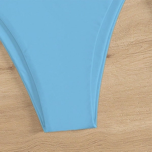 Sky blue sexy bikini bottom with stretch fabric on a light wood background