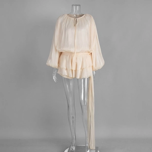 Detail of chiffon long lantern sleeves and ruffled hem on cream summer mini dress