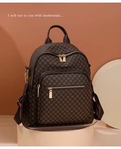 Detail view of large capacity brown monogram backpack for women on a stylish pedestal