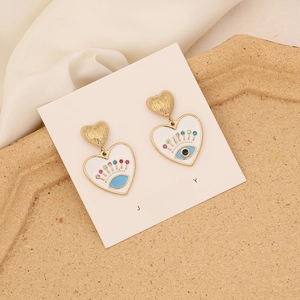 Detail of heart-shaped evil eye earrings with S925 silver needles and colorful crystals