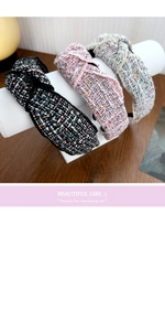 Three knotted tweed headbands in black, pink, and grey on a white cylinder display
