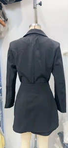 Rear view of black professional blazer and mini skirt set with slim fit silhouette