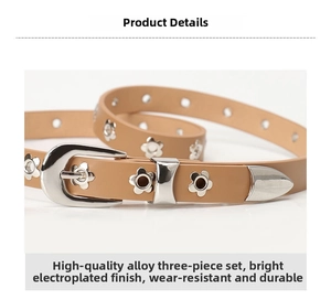 Detail of tan thin leather belt featuring silver alloy buckle and floral metal studs