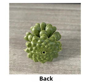 Macro view of green plastic pinecone back side with detailed layered leaf texture