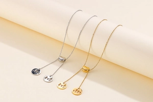 Close-up of gold and silver heart-shaped necklaces with family silhouette pendants