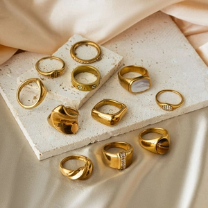 Detail view of 18K gold plated stainless steel rings set with crystals and natural stones