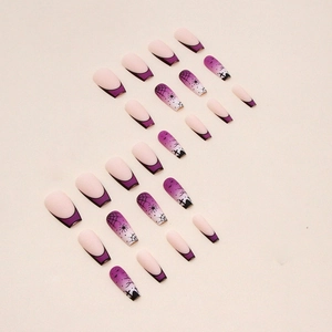 Detail view of purple gradient press-on nails with Halloween spider web and bat designs