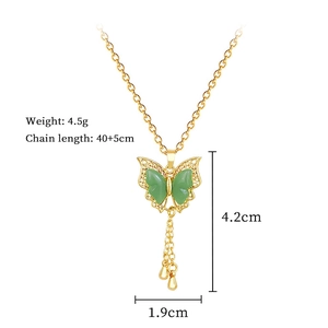 Detail of titanium steel butterfly pendant with green stones and dimensions 4.2x1.9cm