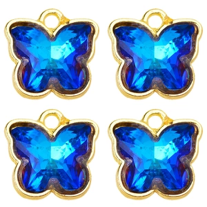 Macro view of four sapphire blue crystal butterfly charms with gold alloy edging