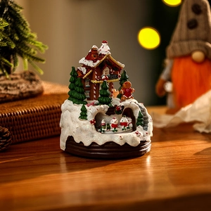 Intricate Christmas music box house with glowing lights and gingerbread man detail.