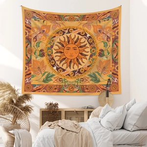 Detailed view of sun and floral patterns on a warm yellow bohemian wall tapestry