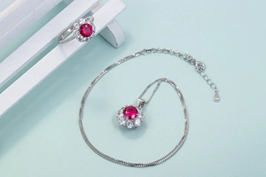 Detailed view of S925 sterling silver stamp on red ruby flower necklace and ring set