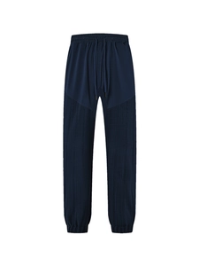 Detailed macro view of dark blue waffle textured fabric and drawstring waist on casual pants