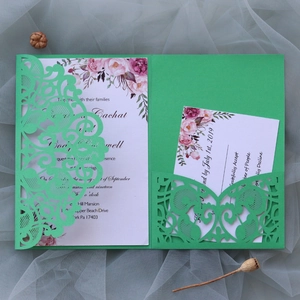 Detail of green laser-cut wedding invitation pocket with watercolor floral card insert