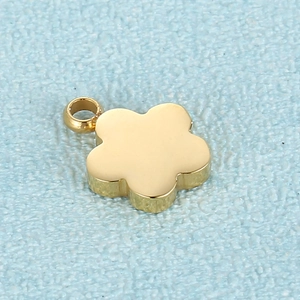 Polished gold flower pendant with five petals on a light blue textured background