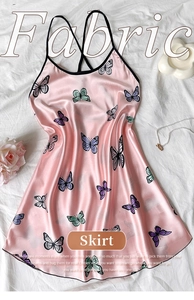 Detail of pink satin slip dress featuring colorful butterfly prints and delicate straps