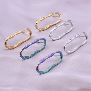 Detailed view of polished stainless steel wave earrings in gold, silver, and rainbow colors