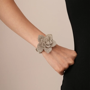 Close-up of model wearing a silver floral cuff bracelet with pavé-set rhinestones