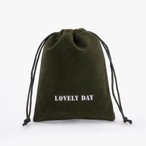 Detail of dark green velvet drawstring pouch with Lovely Day print for jewelry storage