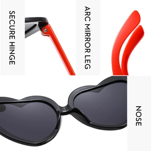Detail of heart sunglasses showing secure hinge, arc mirror legs, and comfortable nose pads