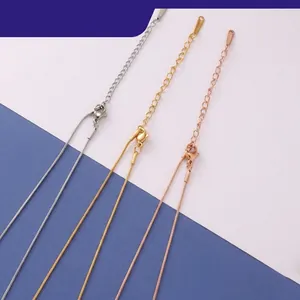 Close-up of gold, silver and rose gold stainless steel necklaces with adjustable lobster clasp