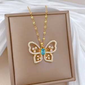 Elegant gold butterfly necklace with blue square gemstone and white diamonds on silk
