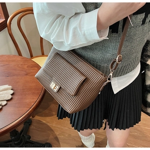 Détail du sac bandoulière marron plissé avec fermoir rotatif métallique doré