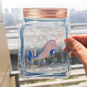Handheld rainbow prism suncatcher sticker in mason jar shape with narwhal pattern