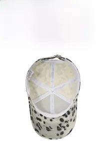 Detail of leopard print baseball cap interior featuring 100% cotton label and stitching