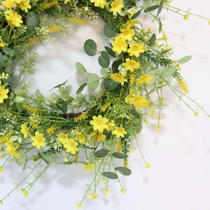 Close-up of artificial yellow daisies and eucalyptus leaves for wedding arch decor